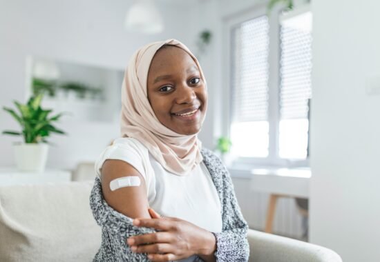 Woman showing plaster from vaccination